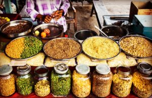 Colorful display of spices and legumes in a traditional Indian street market.